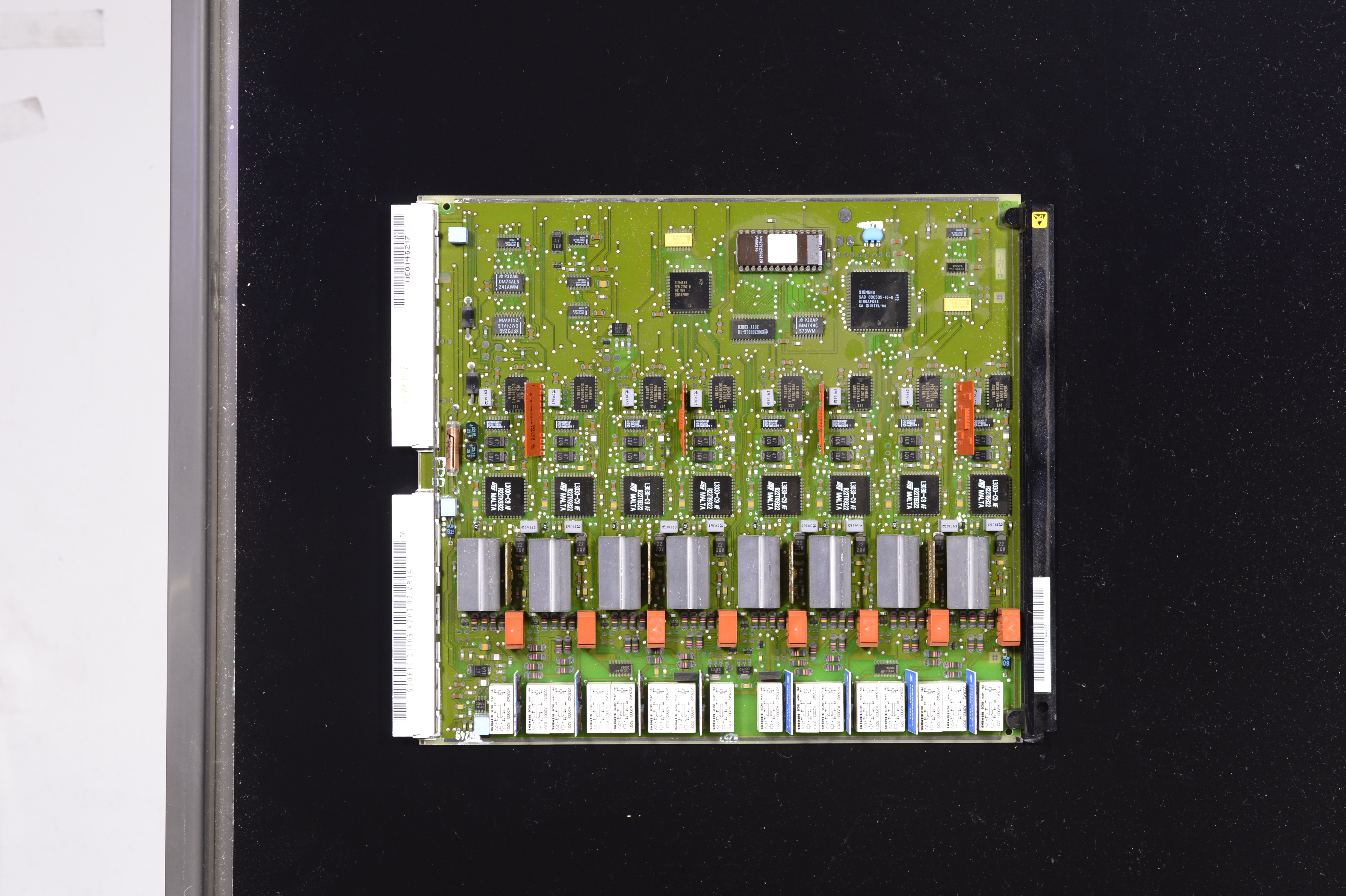 A close-up of a circuit board reveals tantalum capacitors—tiny yet indispensable.
