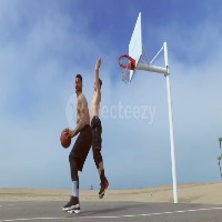 a-man-takes-a-jump-shot-while-playing-one-on-one-basketball-hoops-on-a-beach-court-video (1) project thumbnail
